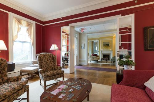 a living room with red walls and a table at Stanton House Inn in Greenwich