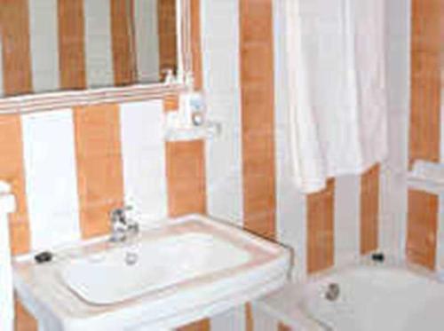 a bathroom with a sink and a tub at Casa Rural Corvina in Acebo