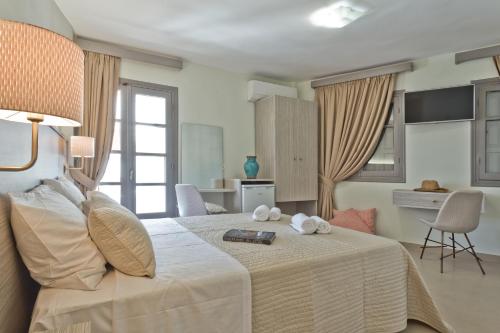 a bedroom with a bed with two towels on it at Nereus Luxurious Suites in Karpathos Town