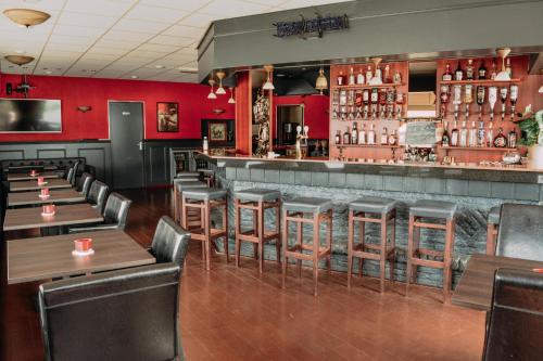 a restaurant with wooden tables and a bar at B&B Hotel Lichtstad in Eindhoven