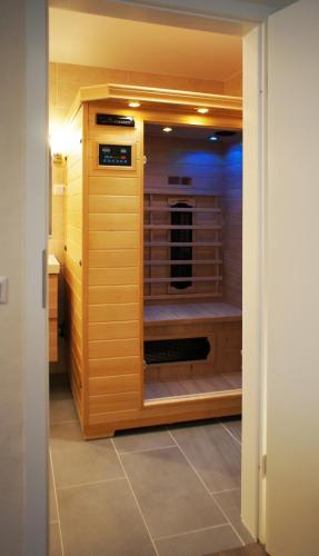 a walk in shower in a kitchen with wooden cabinets at Ferienhaus Dreilinge in Cochem