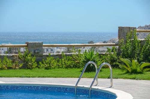 a swimming pool with a view of the ocean at Naxos Luxury Villas in Mikri Vigla