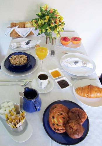 a table with plates of food on a table at Bed & Breakfast Kortenhoefsedijk in Kortenhoef