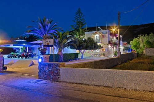 a street at night with houses and palm trees at Blue Sea in Galissas