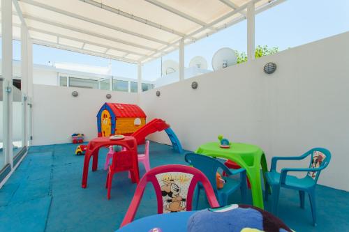 a room with colorful chairs and tables in a room at Georgioupolis Beach Hotel in Georgioupolis