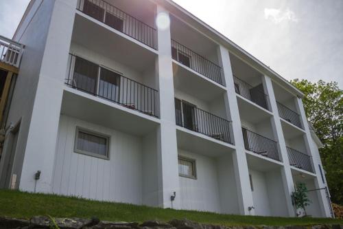 an exterior view of a white building at Belknap Point Inn in Gilford
