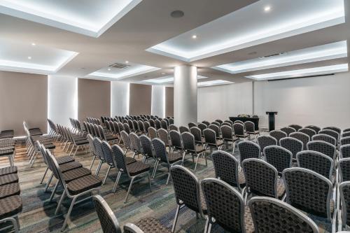 an empty room with rows of chairs and a podium at Hotel Antofagasta in Antofagasta