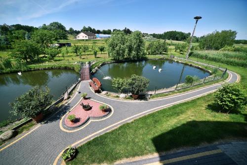 an aerial view of a park with a pond at Hotel Restauracja LORENZO in Stopnica