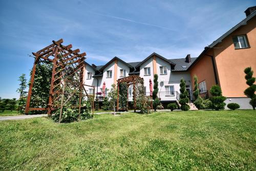 a large house with a large yard in front of it at Hotel Restauracja LORENZO in Stopnica