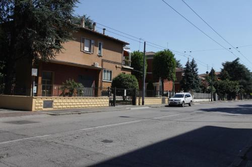 a white car driving down a street next to a building at Casa vacanze Antonia in Bologna