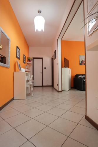 a hallway with orange walls and a tile floor at Casa vacanze Antonia in Bologna