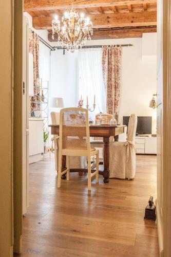 a dining room with a table and a chandelier at Borgo dei Salinari Apartments in Cervia