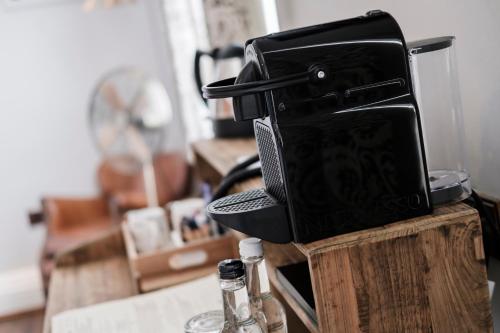a black appliance sitting on top of a wooden table at Hinds Head in Aldermaston