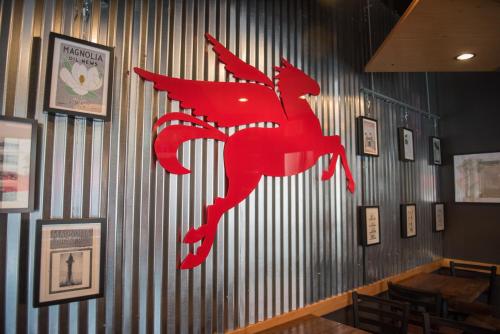 a red dragon on the wall of a restaurant at Magnolia Hotel Downtown Dallas in Dallas