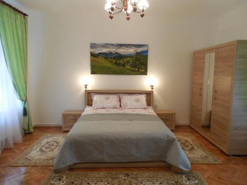 um quarto com uma cama e um quadro na parede em Apartament Anatol em Sibiu