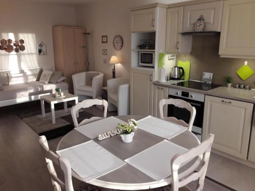 a kitchen and living room with a table and chairs at Chic En Ville in Metz