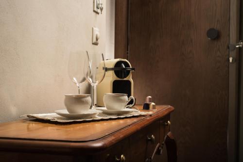 2 tasses sur une table en bois avec une cafetière dans l'établissement Nonnalena Boutique Hotel, à La Canée