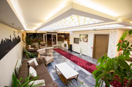 a living room with a couch and a table at Business Han Hotel in Nevsehir