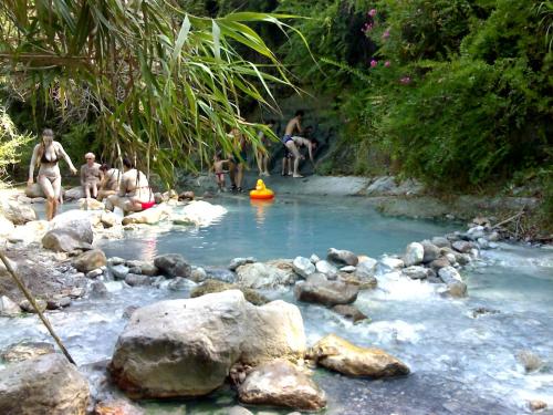 a group of people in a river with rocks at As Casiñas in Ribadavia