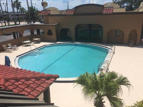 a large swimming pool in front of a house at Days Inn by Wyndham St Augustine/Historic Downtown in St. Augustine