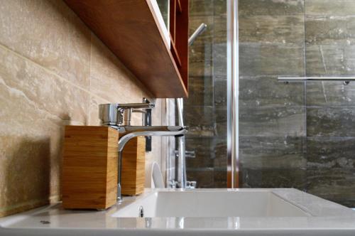 a bathroom with a sink and a shower at Athens Nest in Athens