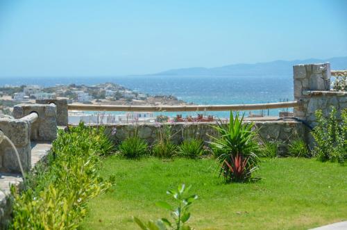 a garden with a view of the ocean at Naxos Luxury Villas in Mikri Vigla