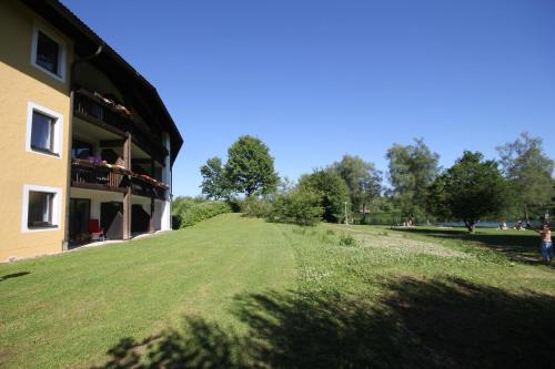 a large grassy field next to a building at Landhaus Sommerau in Buchenberg