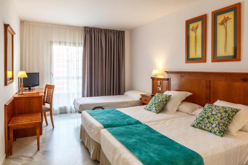 A bed or beds in a room at BQ Andalucia Beach Hotel