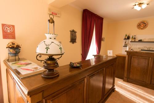 a table with a vase on top of it at Albergo Della Corte in Pescasseroli