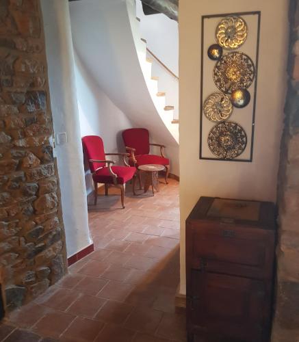a hallway with chairs and plates on the wall at Mas Tomas in Vall-Llobrega