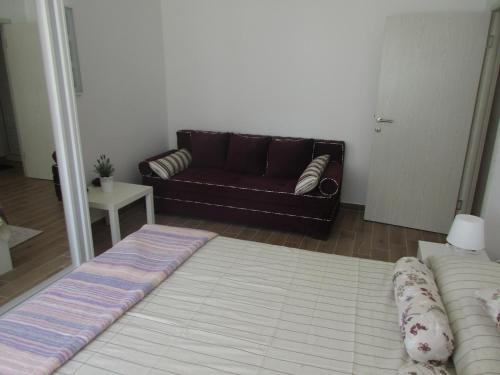 a living room with a couch and a rug at Summer apartment in Bar