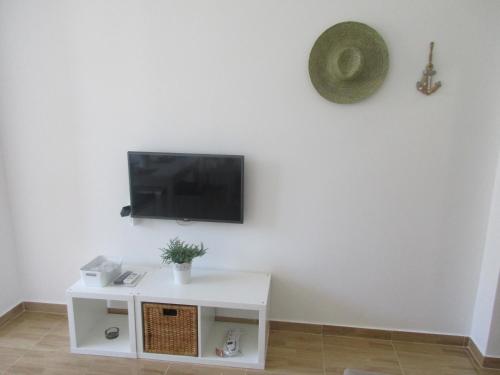 a living room with a tv on a white wall at Summer apartment in Bar