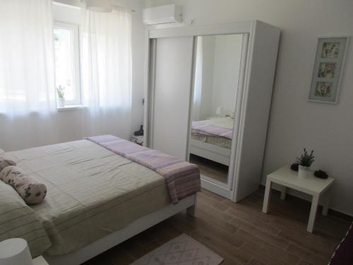 a bedroom with a bed and a large mirror at Summer apartment in Bar