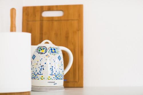 a tea kettle sitting on a counter next to a door at Haapsalu Old Town Apartments in Haapsalu