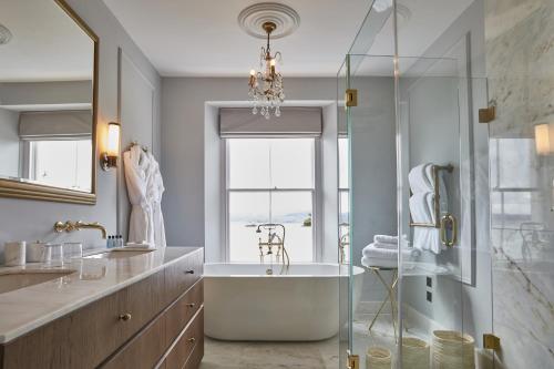 a bathroom with a tub and a glass shower at Lympstone Manor Hotel Restaurant & Vineyard - Relais & Chateaux in Exmouth