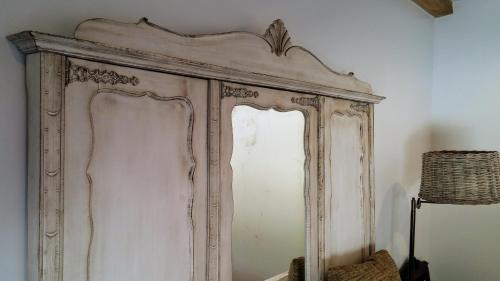 an old wooden cabinet is against a wall at Snug Houseguests in Lisbon