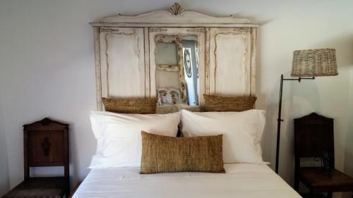 a bedroom with a bed with white sheets and a mirror at Snug Independent Room in Lisbon