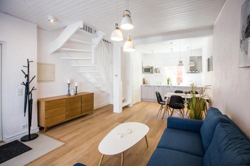 a living room with a blue couch and a table at Haapsalu Old Town Apartments in Haapsalu
