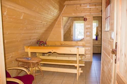 ツァルナ・グラにあるHacjenda - Apartamenty i Pokoje Gościnneのベンチとテーブル付きのログキャビン