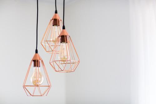 a group of three lights hanging from a ceiling at Haapsalu Old Town Apartments in Haapsalu