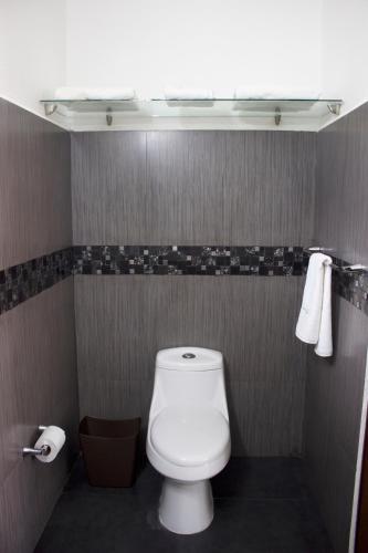 a bathroom with a white toilet and two towels at Ananta Hotel in Las Casitas