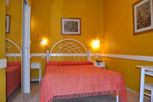 a bedroom with a bed and a yellow wall at Hotel Victoria in Bahía Blanca