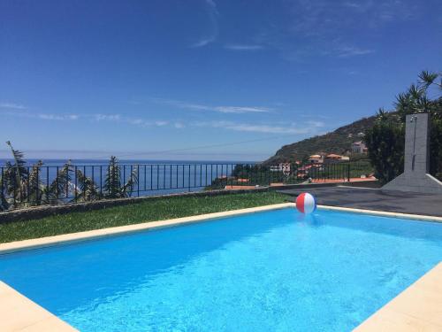 a swimming pool with a beach ball and a volley ball at Villa Atlantis in Calheta
