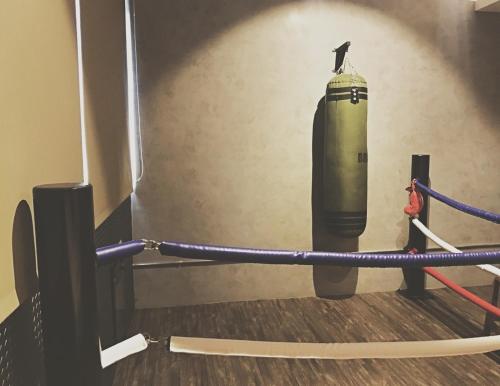 a green fire extinguisher in a room with a wall at Urban in Kaohsiung