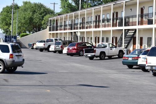 a parking lot with cars parked in front of a building at Town House Inn Cape Girardeau in Cape Girardeau