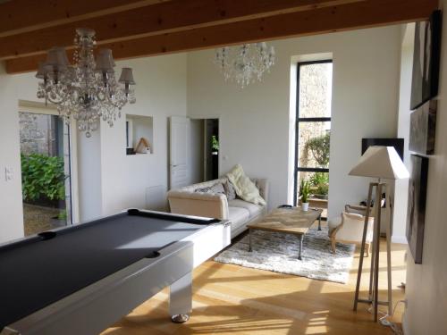 a living room with a pool table and a couch at Manoir de kermilven in Trémeven