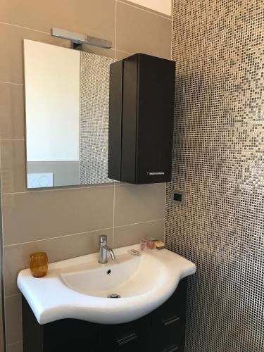 a bathroom with a white sink and a mirror at Mario Al Borgo in San Benedetto del Tronto