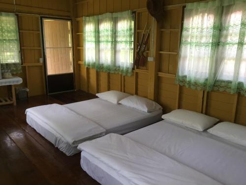 A bed or beds in a room at The Little Lopburi Village