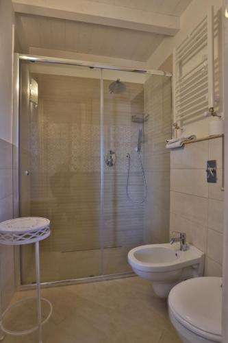 a bathroom with a shower and a toilet and a sink at BdL Open Space in Marsala