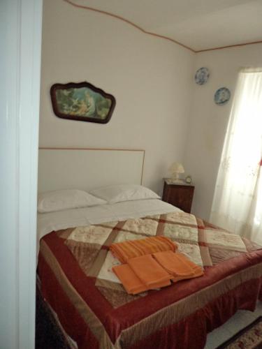 a bedroom with a bed with a quilt on it at Cà da Nonna in Pareto